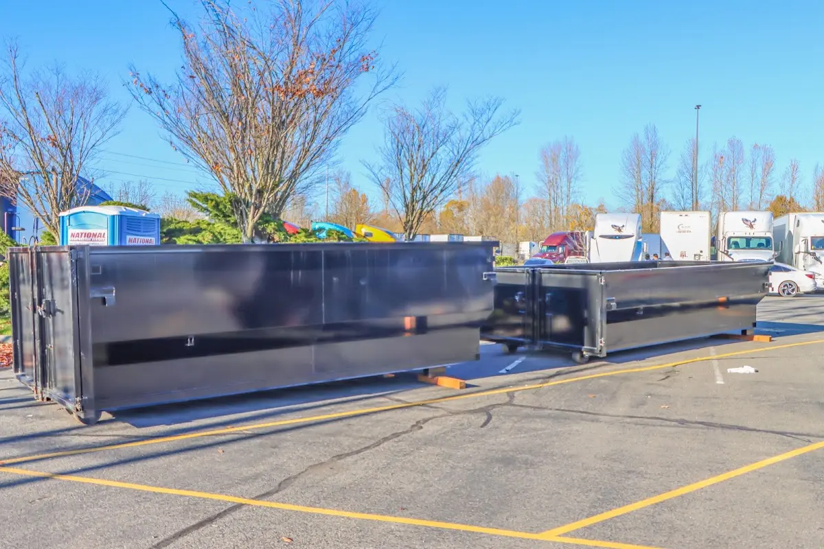 Professional dumpster rental service with roll-off container on residential driveway in Pollock Pines